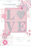 The photograph focuses closely on an anniversary card designed as a gentle celebration of enduring romance, its colouring and composition reminiscent of an elegant supper near Paddington Basin. The central feature is the word LOVE, rendered in soft, raised glitter that forms each letter with clear, confident lines. The texture is velvety and sparkling at once, encouraging fingertips to explore its contours. In place of the letter O, a shimmering heart appears, textured in silver and slightly more pronounced than the surrounding letters. This heart catches the light with a cool, metallic glint, like moonlight on the canal. The word sits upon a blush-pink panel that stands out just enough from the paler background to create depth, while remaining harmonious with the card's overall pastel palette. Around this focal point, delicate blooms in blush and mauve unfold with an almost watercolor softness, their edges gently blurred, evoking petals just opened on a fresh bouquet prepared for delivery to a cosy W2 address. Fine, flowing lines form slender stems, swirling vines, and tiny flourishes-petals, curls, and subtle butterfly shapes-that add a sense of light motion, like a breeze running through an English spring garden bordering Hyde Park. The compositions of the blossoms are balanced, with enough open space between them to keep the design airy rather than crowded. Across the card, the phrases On Our Anniversary and I love you today and always are written in an understated, graceful script, each stroke neat and fluid. The overall effect is one of quiet intimacy and thoughtful design, mirroring the feeling of receiving a carefully curated anniversary bouquet in Paddington-soft as a whisper, yet filled with profound affection.